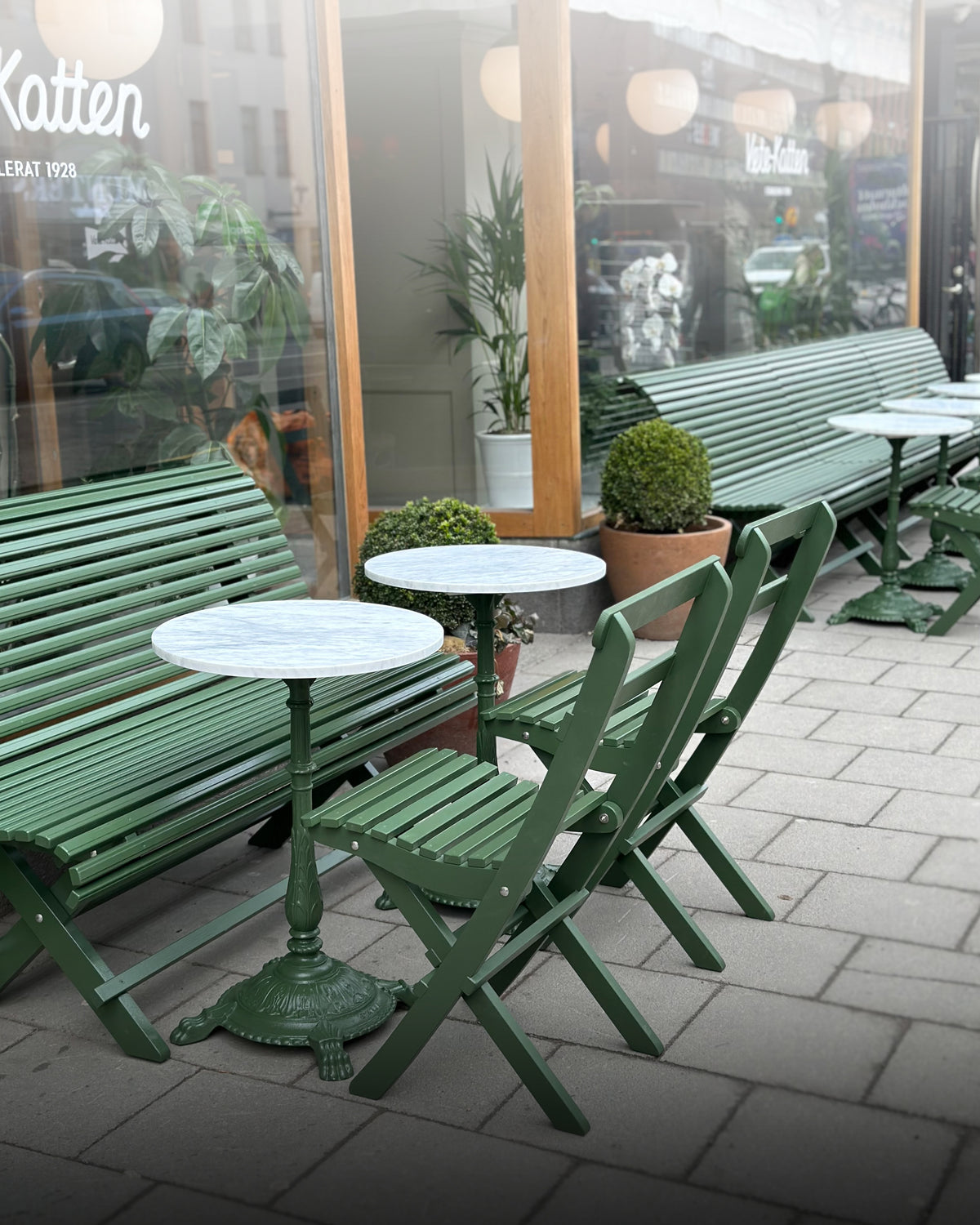Gröna trädgårdsmöbler på Vetekattens uteservering med marmorbord, klassiska utemöbler för café och utomhusmiljö.